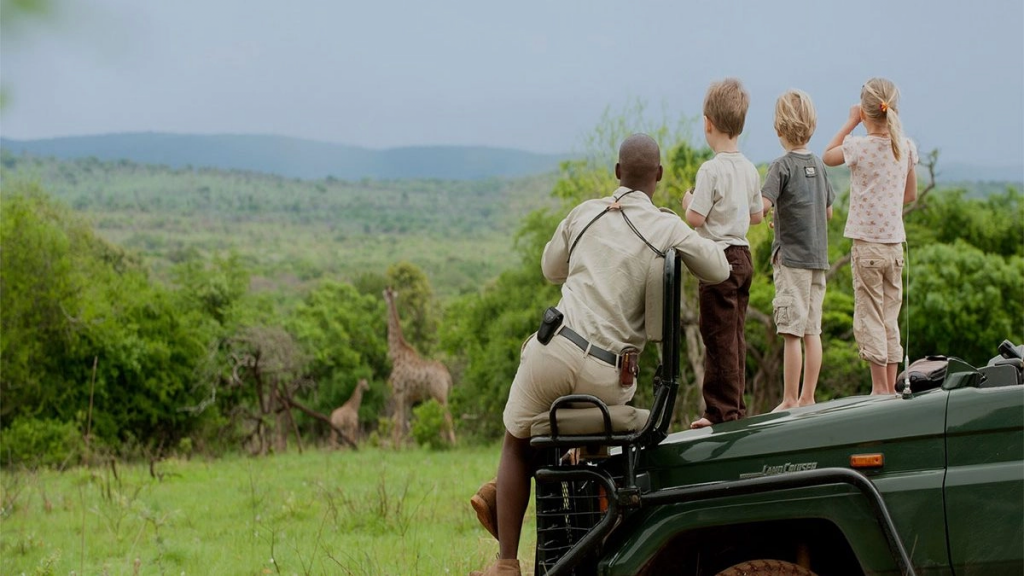Family watching Giraffe in Safari
